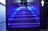 Stairs with bright blue LED lighting under each step and industrial design at Undefeated Gym Bali