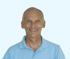 A smiling man in a bright blue polo shirt.