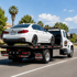 Towing Corona flatbed towing service transporting a sedan securely on a flatbed tow truck along the highway.