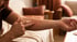 A man touches a red, irritated skin rash on his inner forearm with two fingers.