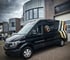 Black LP Koper & Zinkprojecten BV van parked outside a modern building with company logo and text.