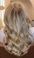 Rückansicht von langem, blondem Haar mit sanften Wellen und hellen Highlights.