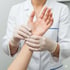 A professional examines a patient's wrist to check for neuropathic pain.