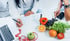 Dietitian planning personalized dietary guidance with fresh, healthy foods.
