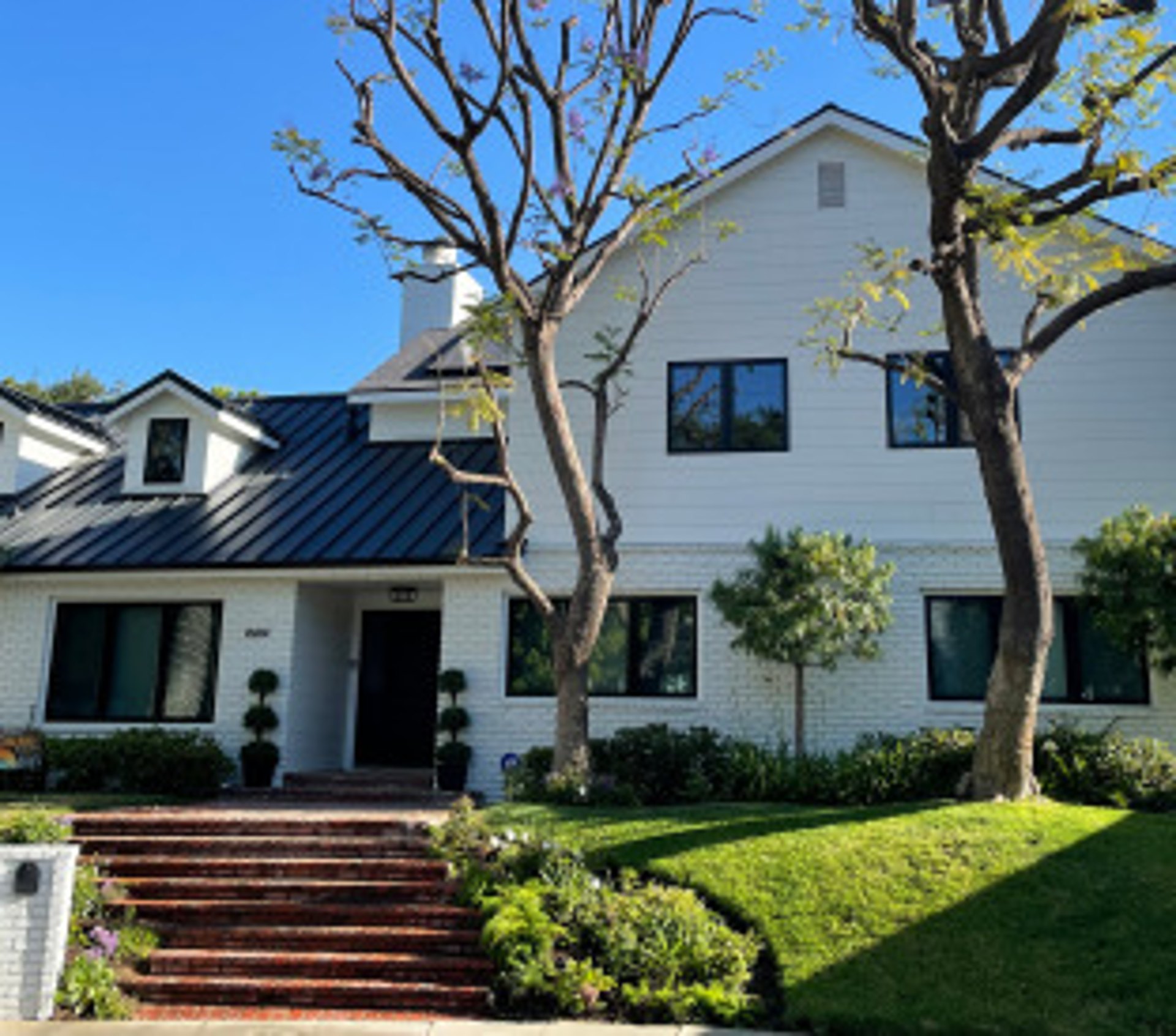 Home with white brick and arctic white James Hardie siding in Encino, CA installed by Approved Contractor, Inc.