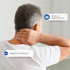 A person from behind rubs their neck, feeling pain.