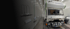 Ein weißes Wohnmobil auf LKW-Basis steht zur Lackierung oder Reparatur in einer hellen Werkstattkabine.