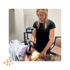 Therapist applying tissue regeneration device on arm