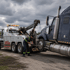 Towing Deltona heavy-duty towing service recovering a semi truck with a professional wrecker under stormy skies