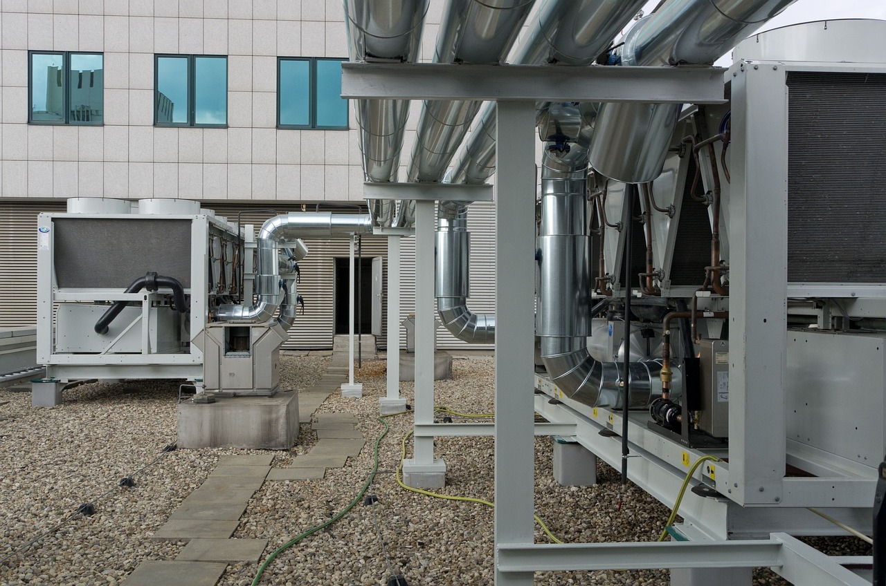 Rooftop HVAC units on a commercial flat roof in Carrollton, TX, where owners weigh TPO vs modified bitumen