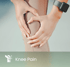 Hands clutching a knee, indicating knee pain.