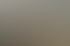 Mechaniker wuchtet einen Reifen an einer Auswuchtmaschine in einer Werkstatt mit Falken-Banner aus.