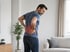 Man experiencing lower back pain and discomfort treatment focus