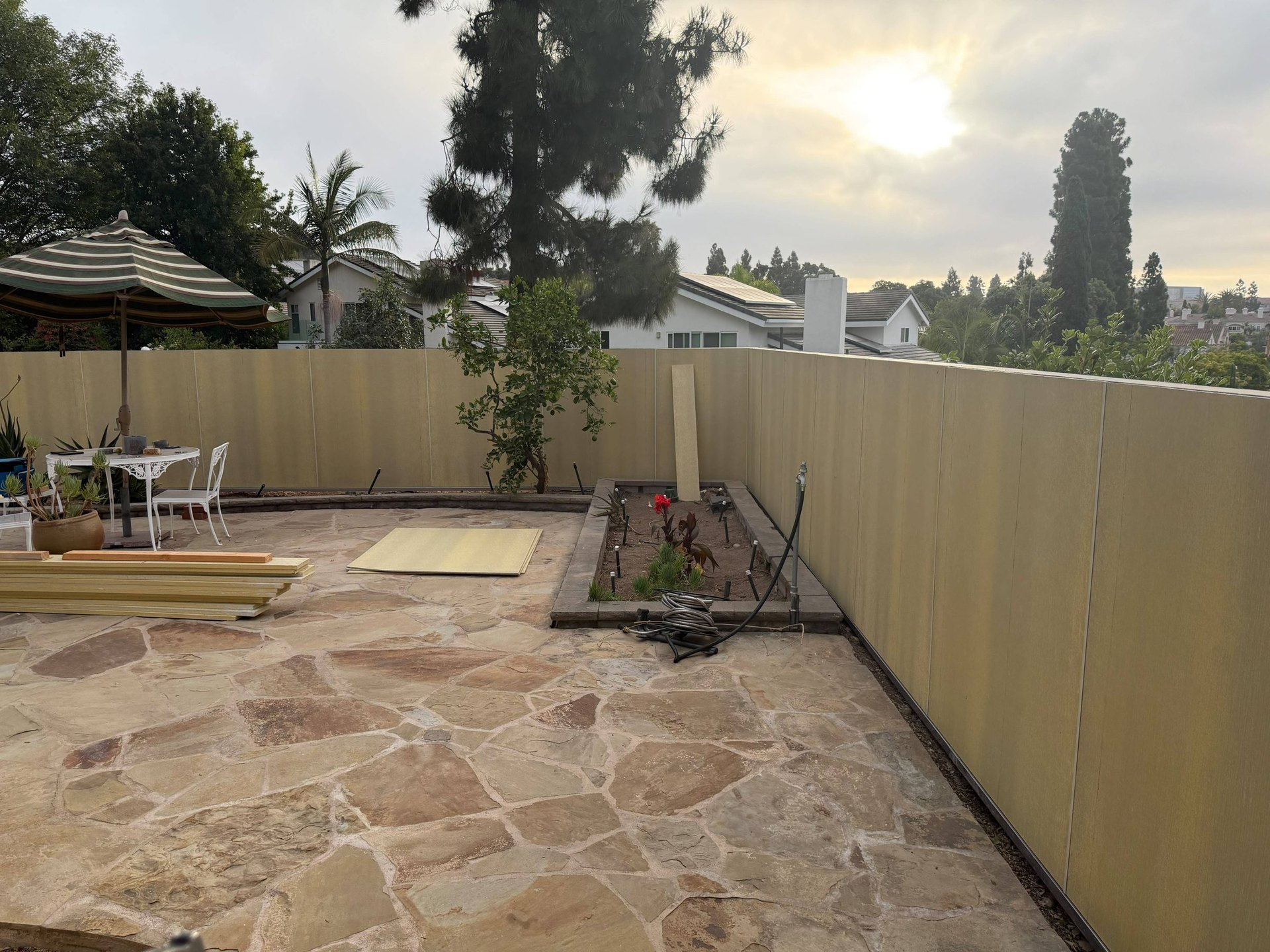 James Hardie Architectural Panels being installed on a backyard patio fence in San Diego