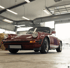 Roter Porsche 911 Sportwagen in einer Garage, Kennzeichen: OL TU 77H