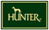 Goldenes Hunter-Logo mit Windhund auf dunkelgrünem Hintergrund.