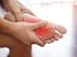 Close-up of foot pain with red glow highlighting neuropathy symptoms.