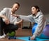 Woman training with Physical therapist to improve strength and mobility