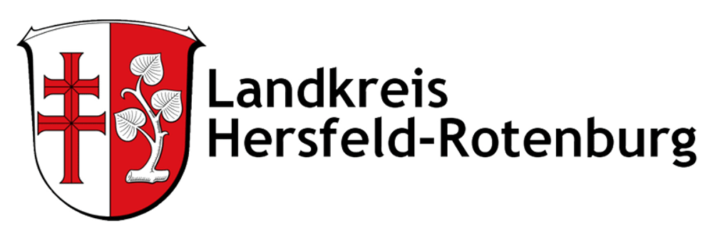 Wappen des Landkreises Hersfeld-Rotenburg mit rotem Doppelkreuz, silbernen Blättern und schwarzem Text.