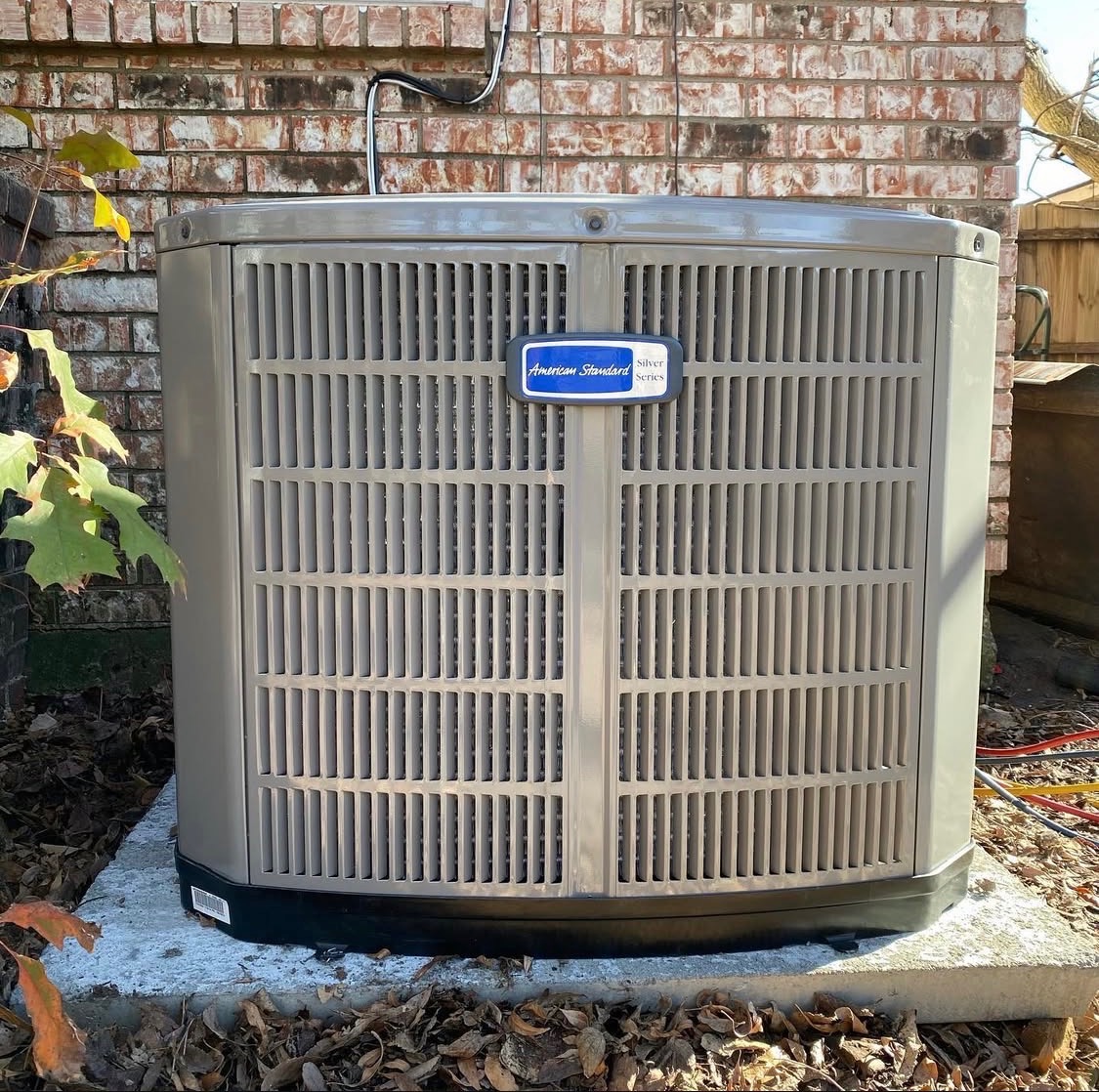 American Standard Silver Series condenser installed on a concrete pad