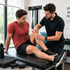 Regenerative sports clinic therapist examines patient’s knee