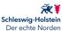 Schleswig-Holstein Logo: Blauer Löwe, rotes Nesselblatt, Text "Schleswig-Holstein Der echte Norden" auf grünem Grund.