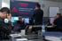 Mehrere Personen in einem Büro vor Bildschirmen mit einer großen roten IT-Störungsmeldung "System down" - Software-KRITIS Notfall- und Krisenmanager (NKM®).