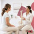 Chiropractor in medical clinic points to spine model
