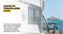 Weißes Wohnmobil mit "HOME OF TRAVELLERS 2026" Text, am Meer mit einer Stadt im Hintergrund.
