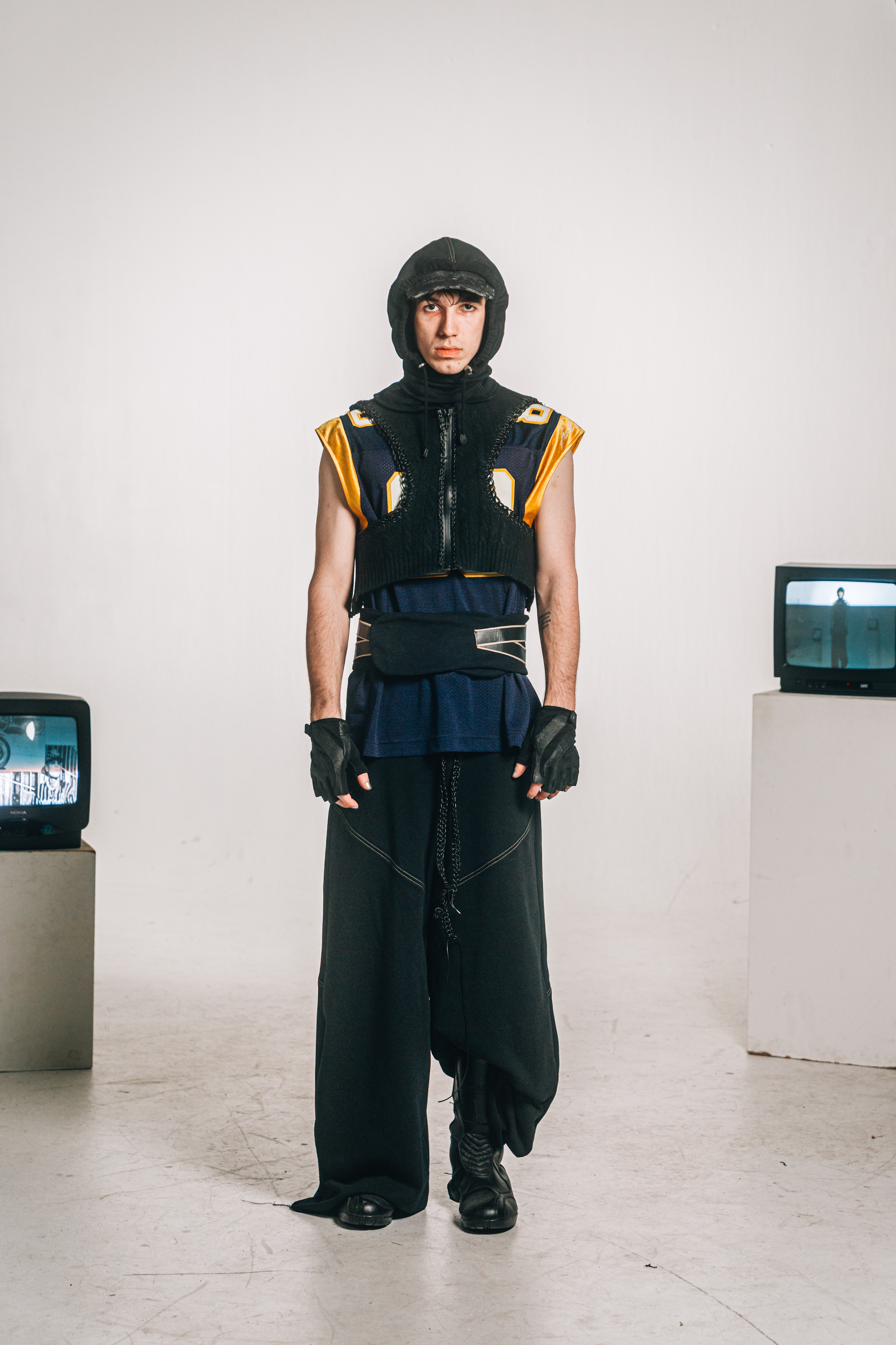 Wide-leg sports trousers with leather elements and deconstructed protective vests