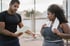 Personal trainer checking a woman’s waist with a measuring tape outdoors for insulin resistance monitoring