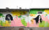 Colorful street mural featuring portraits of two women and the word "Fearless" in cursive script.