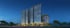 An aerial view of a large, clear blue swimming pool with surrounding wooden deck, lounge chairs, and potted trees.