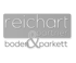 Graues Logo mit Text "reichart & partner boden & parkett".
