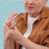 Older woman holding her painful hand — joint wear and tear relief at Accelerated Medical in Elko, NV