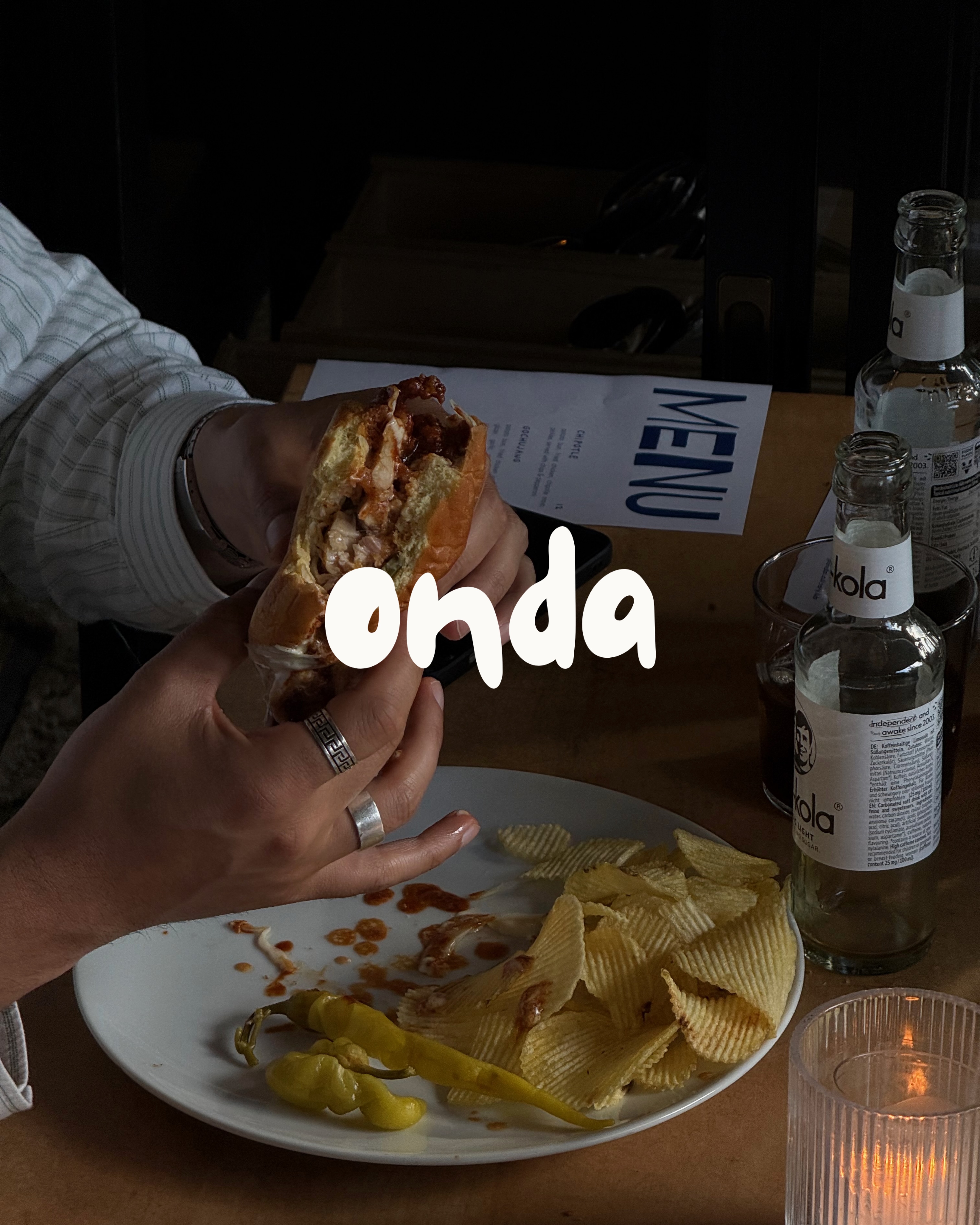 Dinner table with a sandwich, chips and drinks
