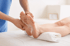 A healthcare provider massaging a patient's foot for plantar fasciitis.