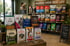 Pet store display with various brands of dog and cat food bags, "NOURISH THEIR BEST LIFE" sign.