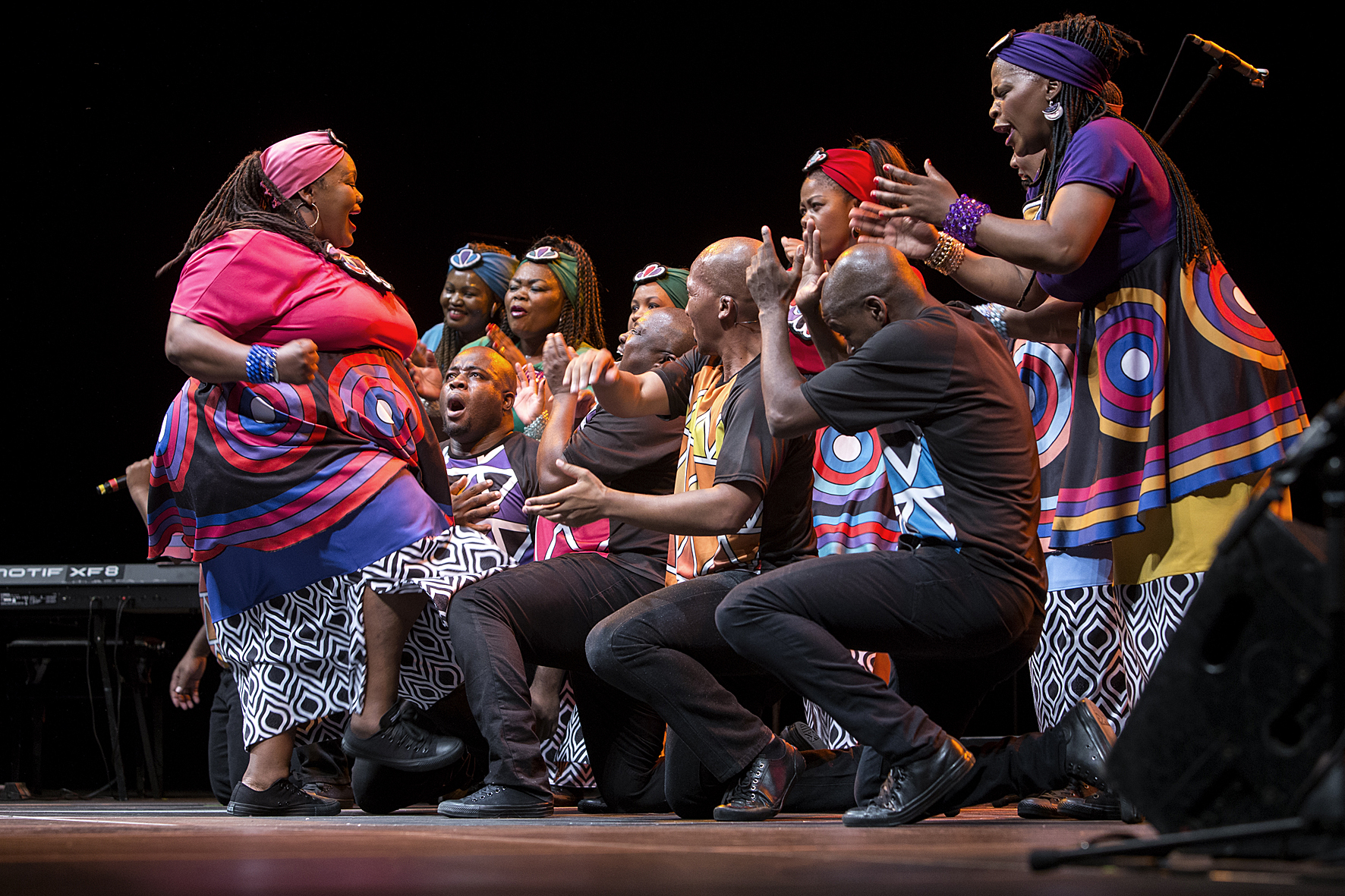 Soweto Gospel Choir in colourful costumes on the Stadthalle stage, Voices of Spirit 2016, Graz