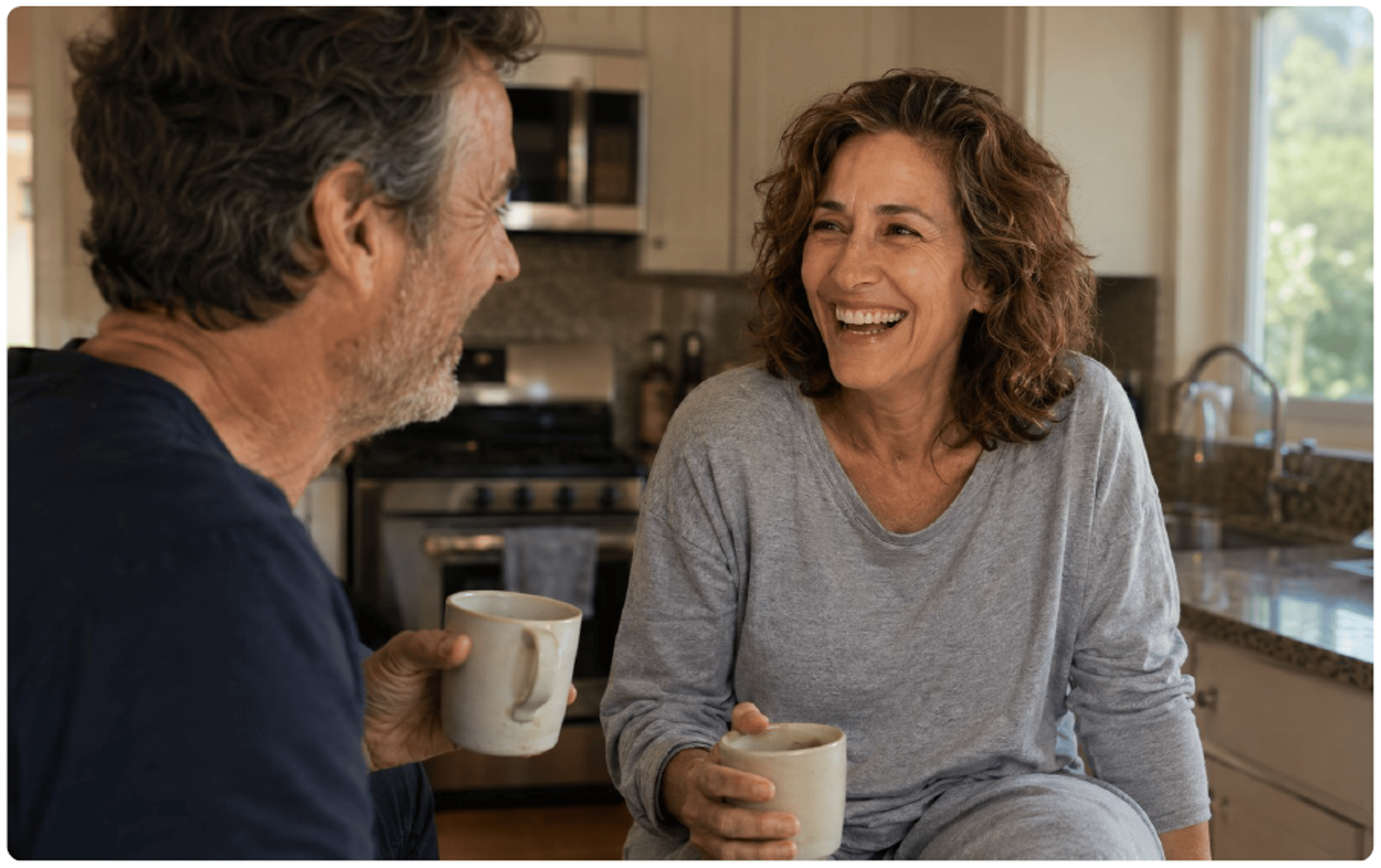 Couple laughing in kitchen