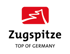 Zugspitze Logo: Rotes Bergpiktogramm, darunter "Zugspitze" und "TOP OF GERMANY" in Schwarz.