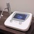 Oceanus Medical System shockwave therapy machine with a digital screen, two control knobs, and a silver handpiece.