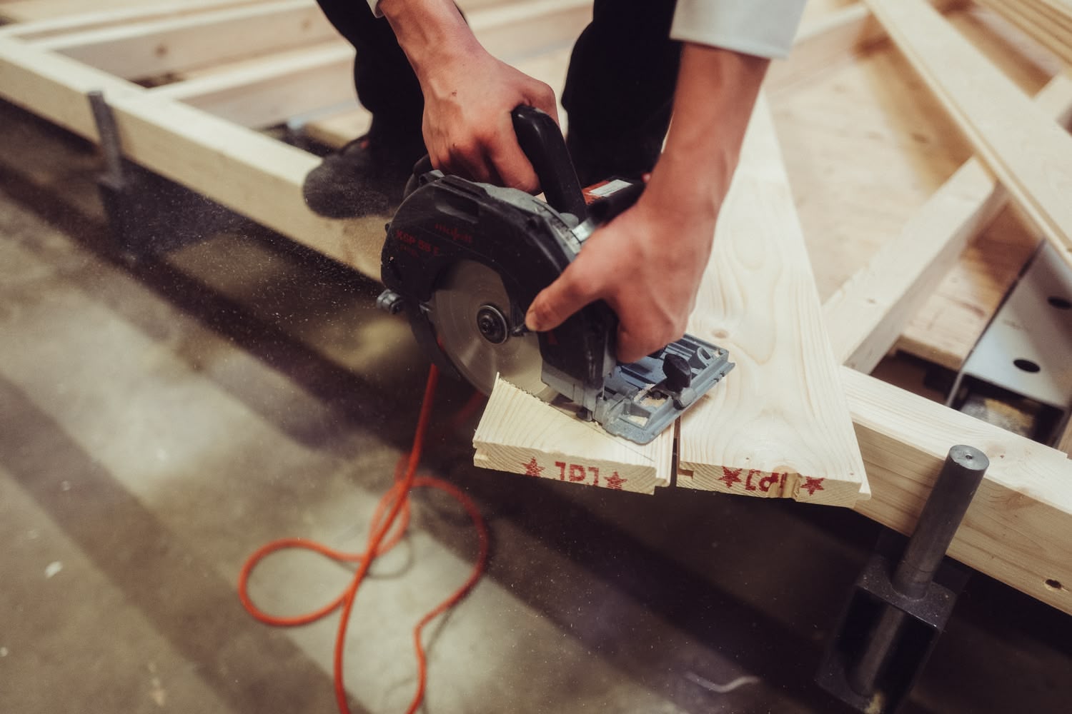 Hände am Werkstück in der Halle von Holzbau Stocksiefen