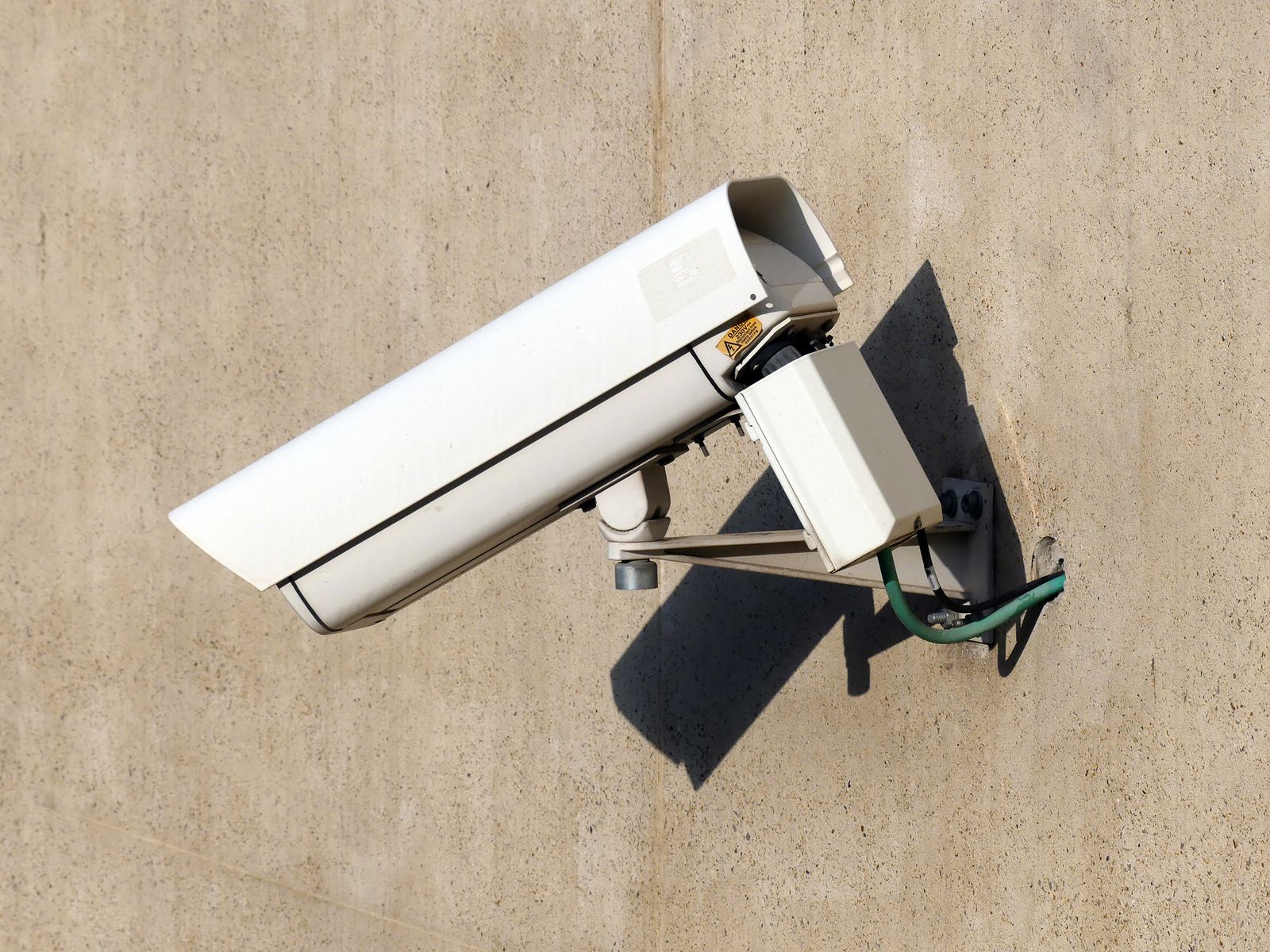 Security camera on a sunlit exterior wall