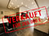 Wohnzimmer mit Esstisch, Sofa und Fernseher, roter Stempel "VERKAUFT FÜR 265.000 €" überlagert.