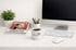 Desk setup with beauty and lifestyle magazines, a computer, and a branded Peter Sechehaye coffee mug