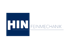 Logo von HIN Feinmechanik mit weißem Text in einem blauen Quadrat auf schwarzem Hintergrund.