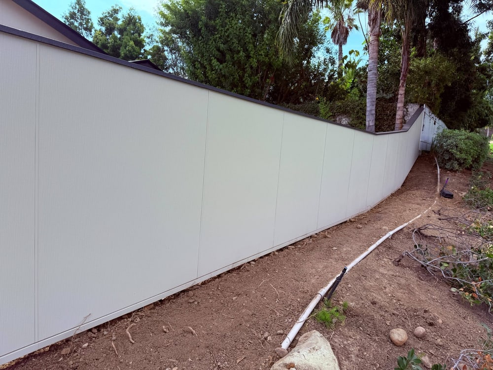 Fiber cement fence following the slope of a San Diego lot
