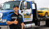 Towing Port Charlotte driver beside a flatbed tow truck transporting a yellow car for professional towing service.
