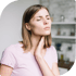 Thyroid disorder symptoms in a woman holding her throat